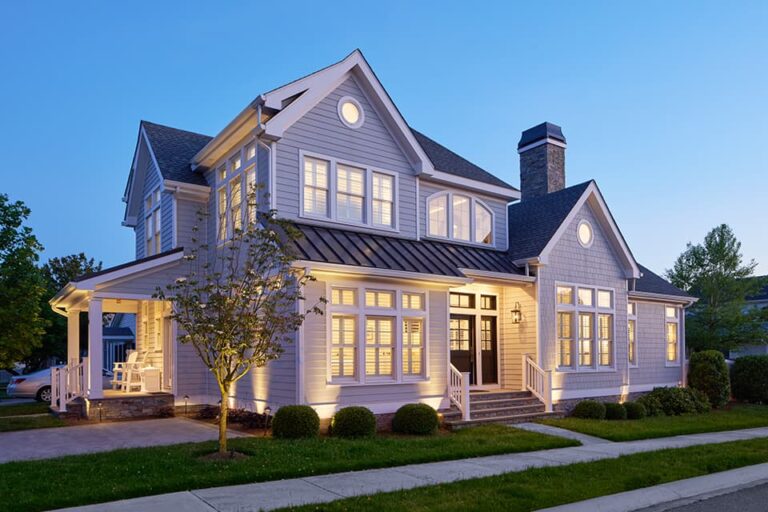 Evening photo of a Country Club Classic home with glowing dramatic lighting